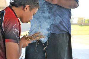Firemaking Kid With Smoke And Straw Hero Shot