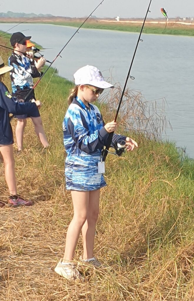 Girl On Banks Fishing