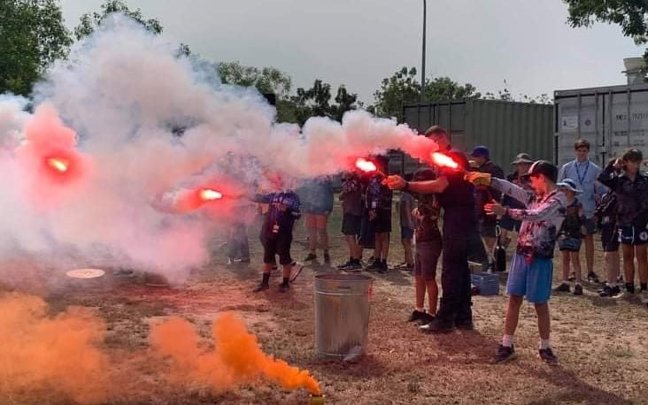 Kids Are Playing Orange And Red Smoke Signal Flares