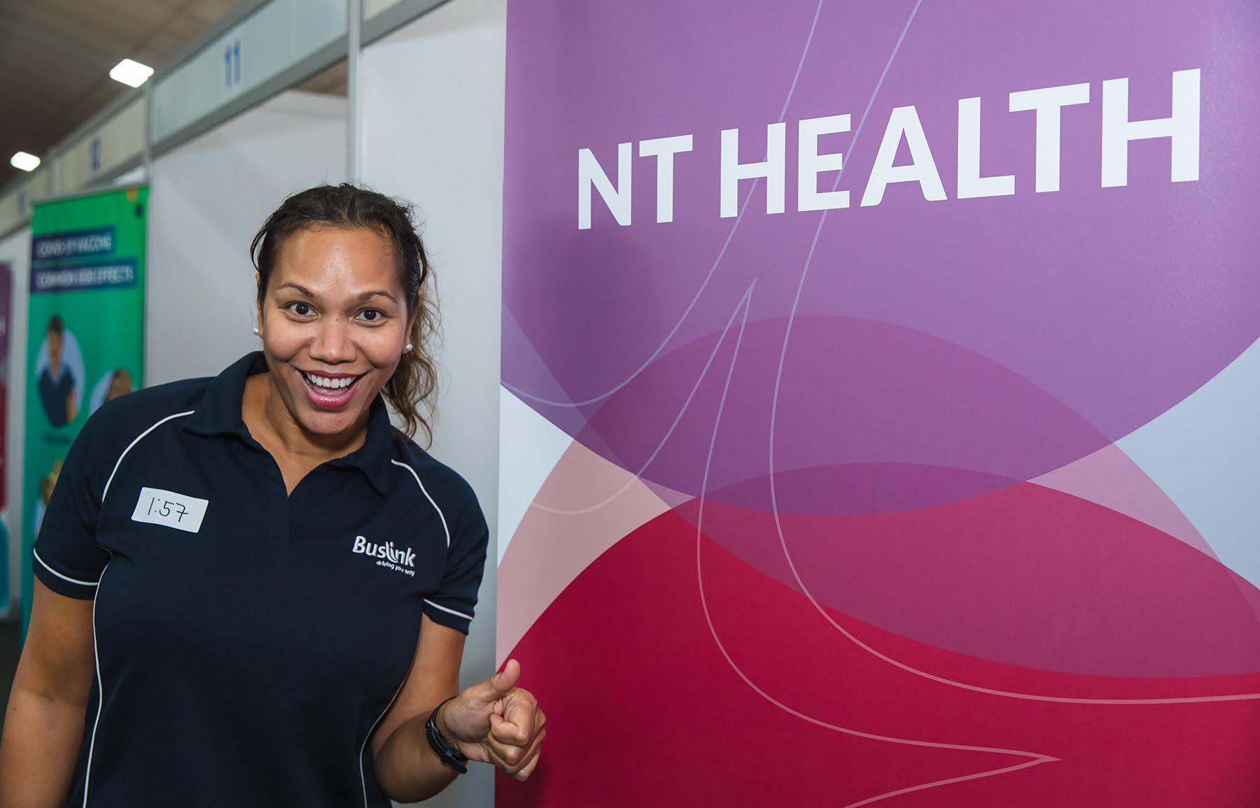 Pele Wendt Smiling In Front Of The NT Helath Poster