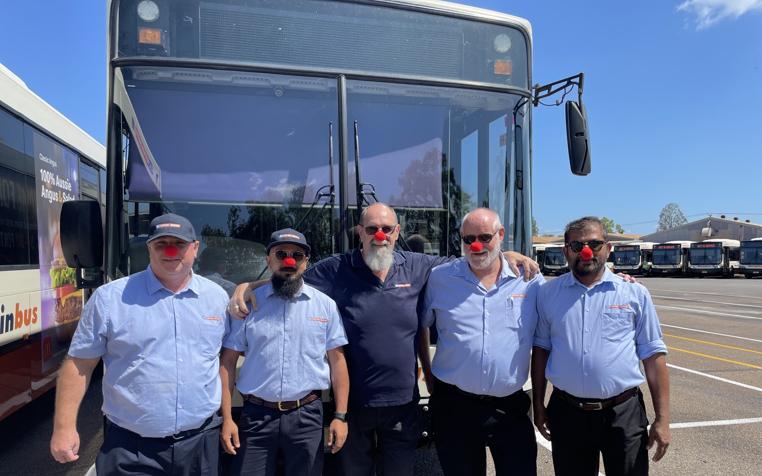 Ross and other CDC staff standing in front of a bus