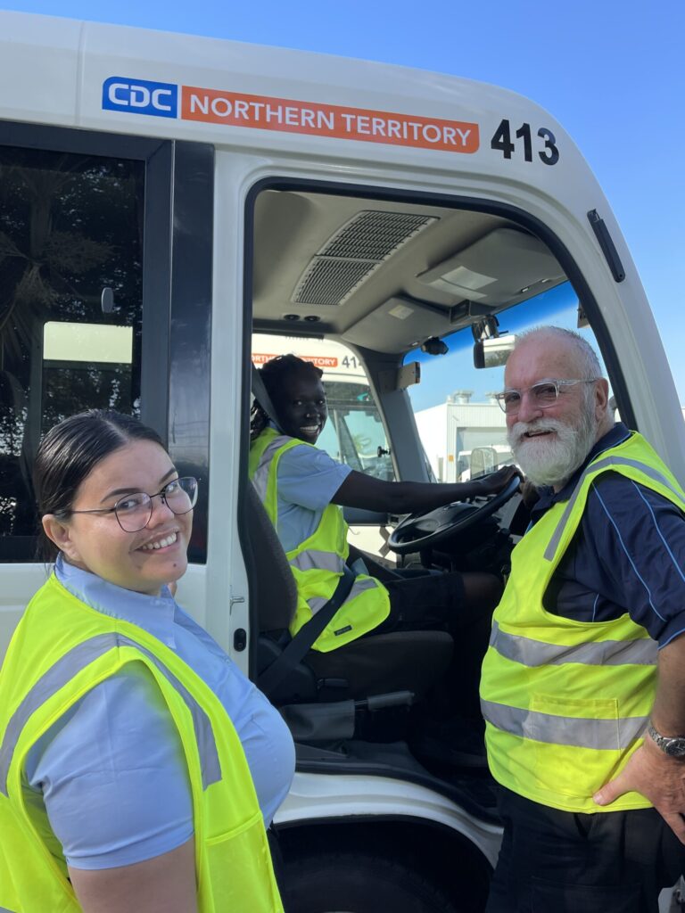 CDC staff standing in front of a bus