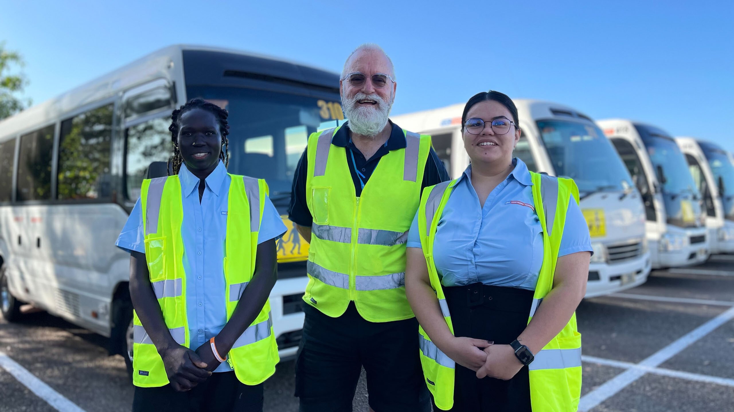 CDC NT Staff Smiling in front of buses