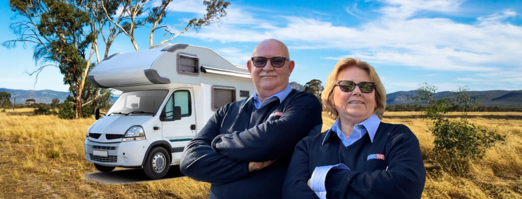 Senior Drivers Smile In Front Of Bus